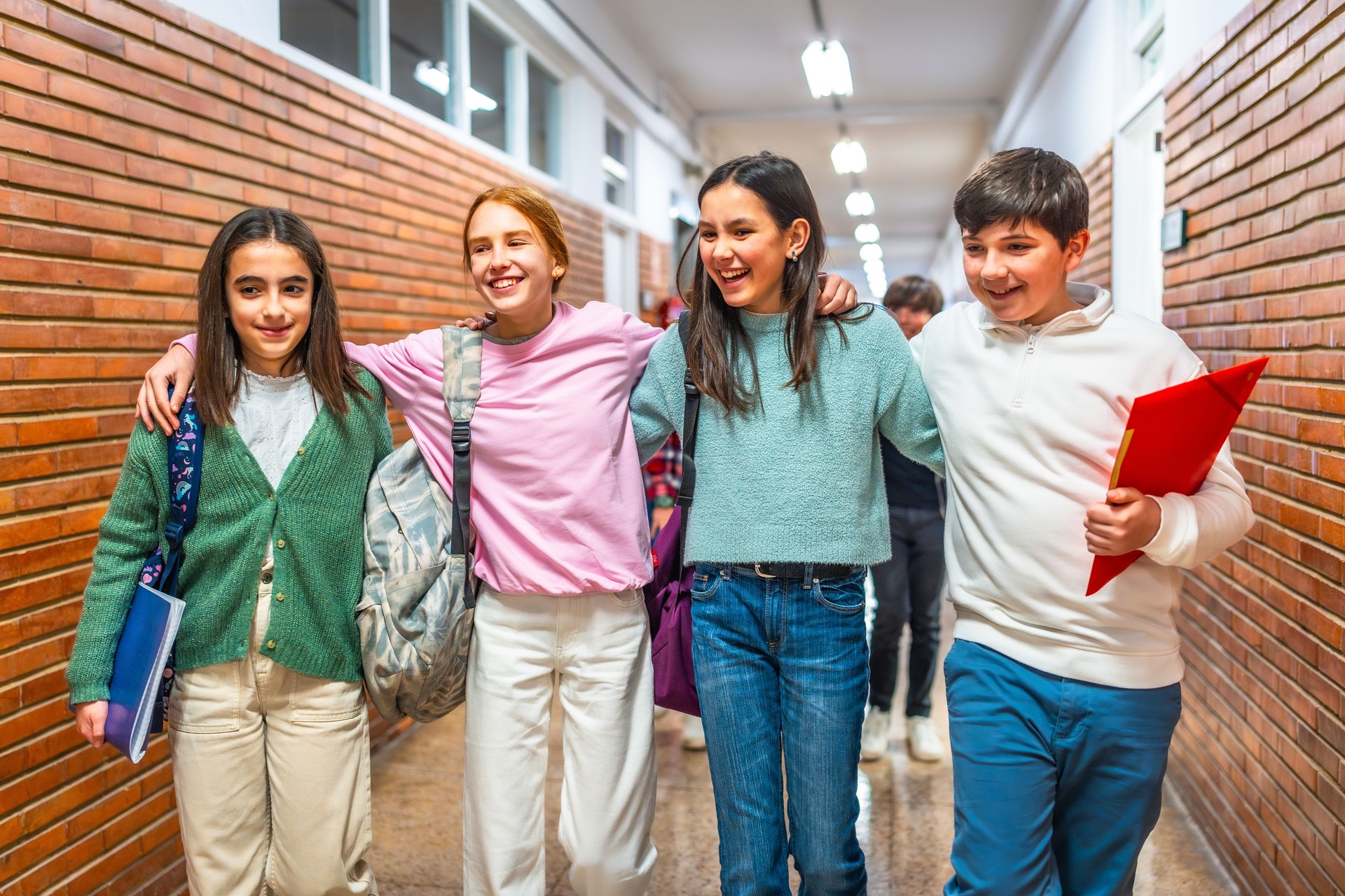 Group of students walking down school hallway